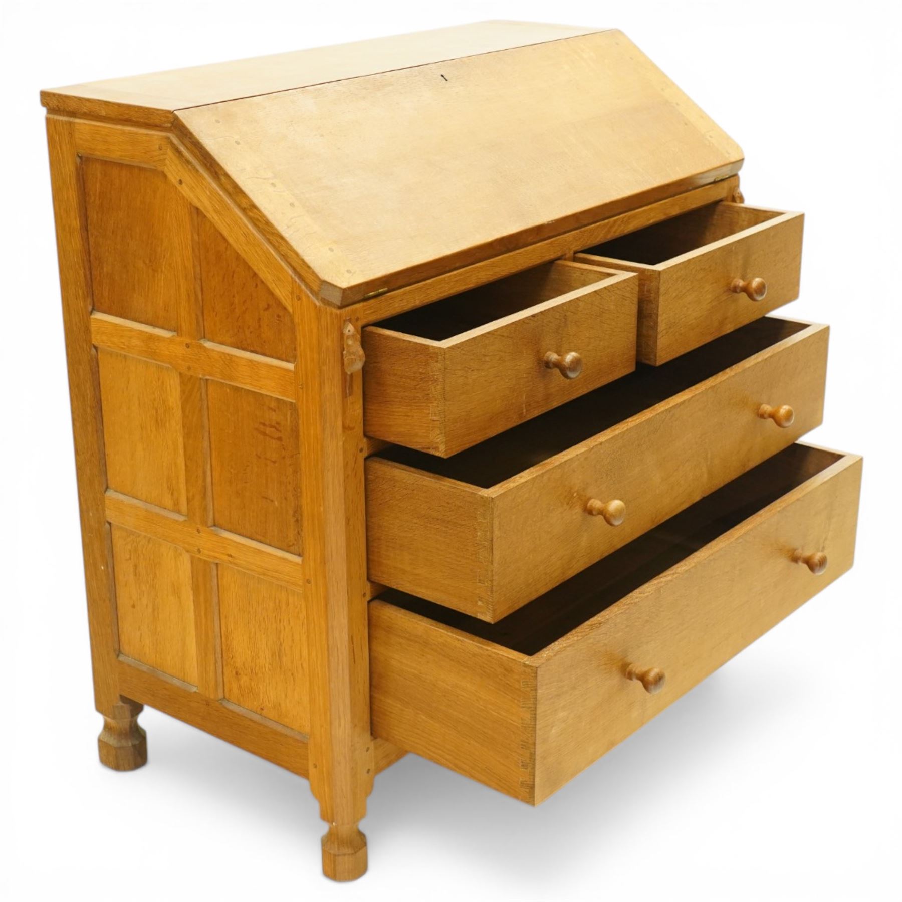 Mouseman - oak adzed bureau, fall front with carved mouse lopers, with fitted interior, above two short over two long drawers, by the workshop of Robert Thompson of Kilburn
