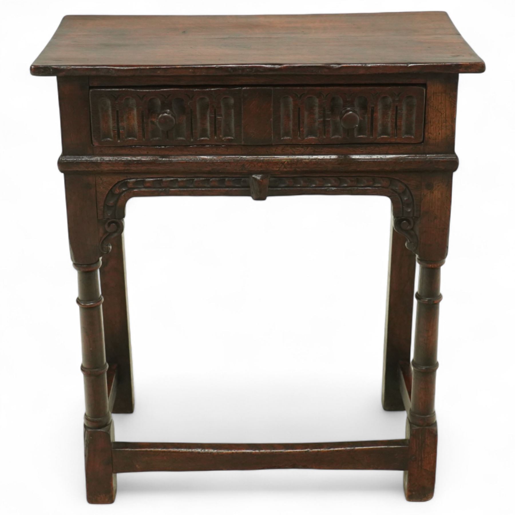 Titchmarsh & Goodwin style oak side table, rectangular top above a carved frieze drawer fitted with turned knobs, raised on block and baluster legs with plain stretchers 
