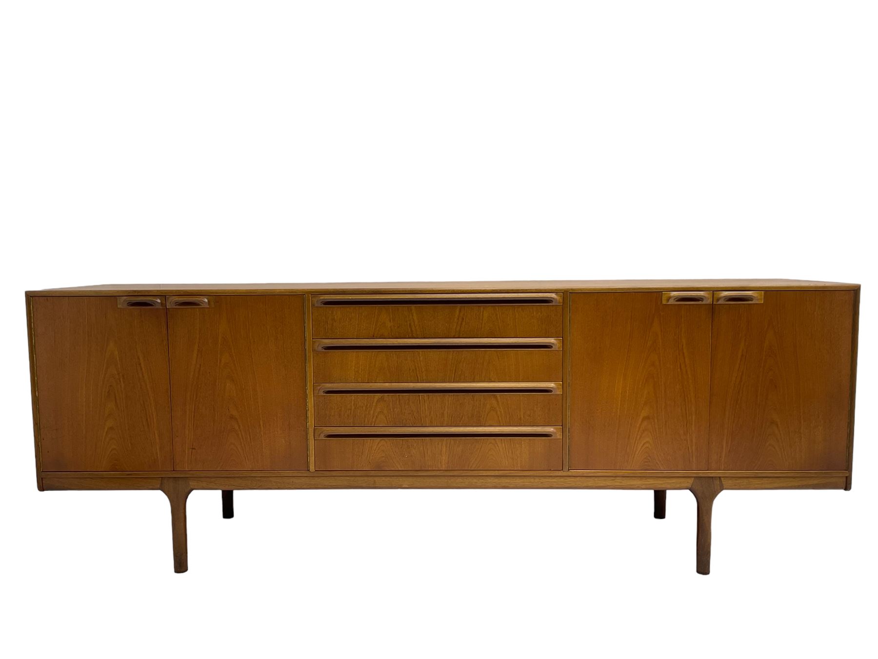 Tom Robertson for AH McIntosh & Co of Kirkaldy - mid-20th century teak sideboard, fitted with four central drawers, flanked by cupboard enclosing shelves and sliding tray, raised on cylindrical supports