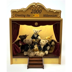 Steiff limited edition 'Millenium Dream Band' of five teddy bears on a stage playing various musical instruments, steps to the front and fitted velvet type curtains, wind-up musical movement playing 'When The Saints Go marching In' H60cm W50cm D31cm. Unboxed and lacking certificate.