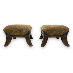 Pair of early 20th century miniature footstools, square seat covered in gold and orange floral patterned tapestry fabric, on carved wooden frame with splayed supports 