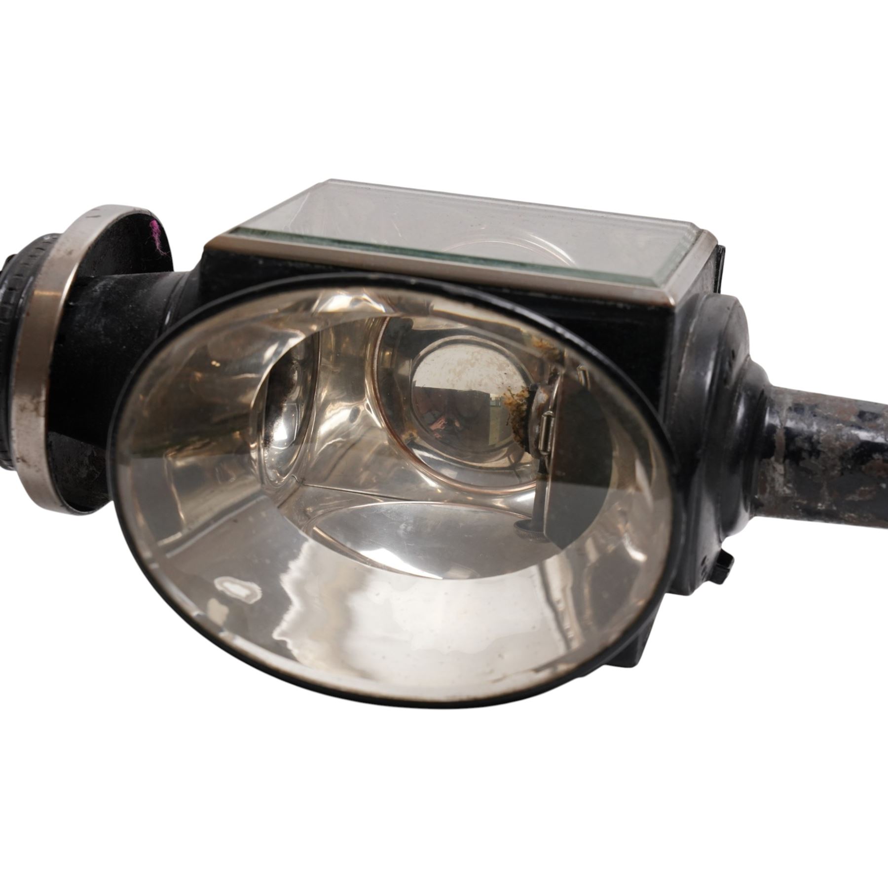 Hamshaw (Leicester) - pair of Edwardian white metal and toleware carriage lamps, the pagoda moulded with patera motif, over a rectangular body with oval convex lens and bevelled glass and reflective panels, cylindrical stem, maker engraved to candle mount
