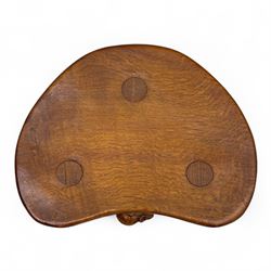 Mouseman - oak three-legged calf stool, kidney-shaped seat carved with the signature mouse motif, by the workshop of Robert Thompson, Kilburn