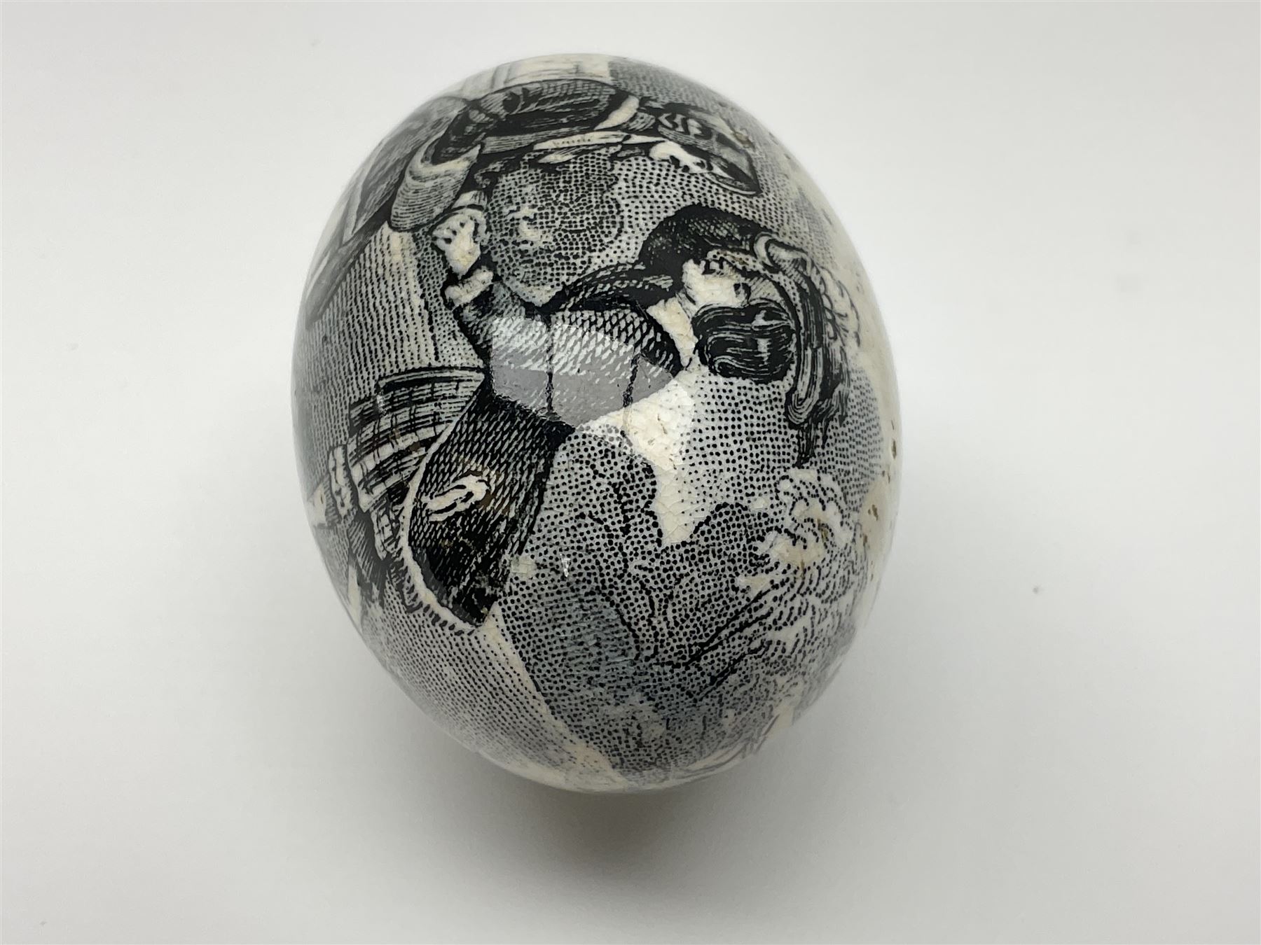 Victorian pottery egg transfer, printed with scenes 'Androcles and the lion' and a courting couple, L7cm 