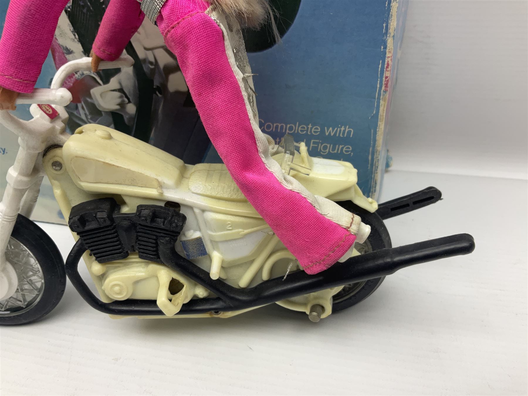 Ideal Derry Daring and Her Trick Cycle, with clothed figure on trick cycle and winder; in original illustrated box dated 1975