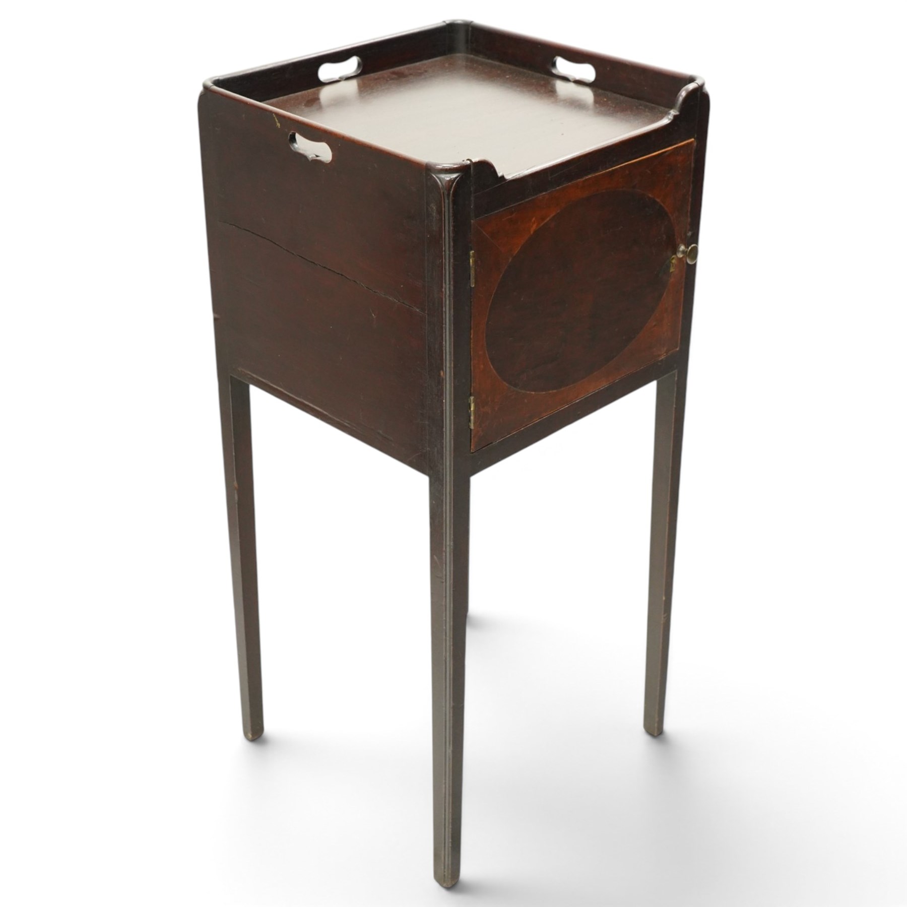 George III mahogany bedside pot cupboard, rectangular tray top with raised three-quarter gallery with pierced handles, fitted with single cross-banded cupboard, on square tapering supports