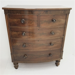 Victorian mahogany bow front chest, two short and three long drawers, turned supports, W113cm, H132cm, D54cm