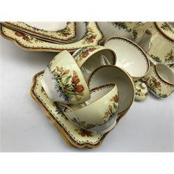Early 20th century Crown Ducal part tea service decorated in  the Tulip pattern, to include six teacups and saucers, five side plates, cake plate, two comports, hot water pot, sucrier, jugs, bowls etc, all with printed black mark beneath c1925 onwards and U.S.A PAT. 72944 Reg No. 732597