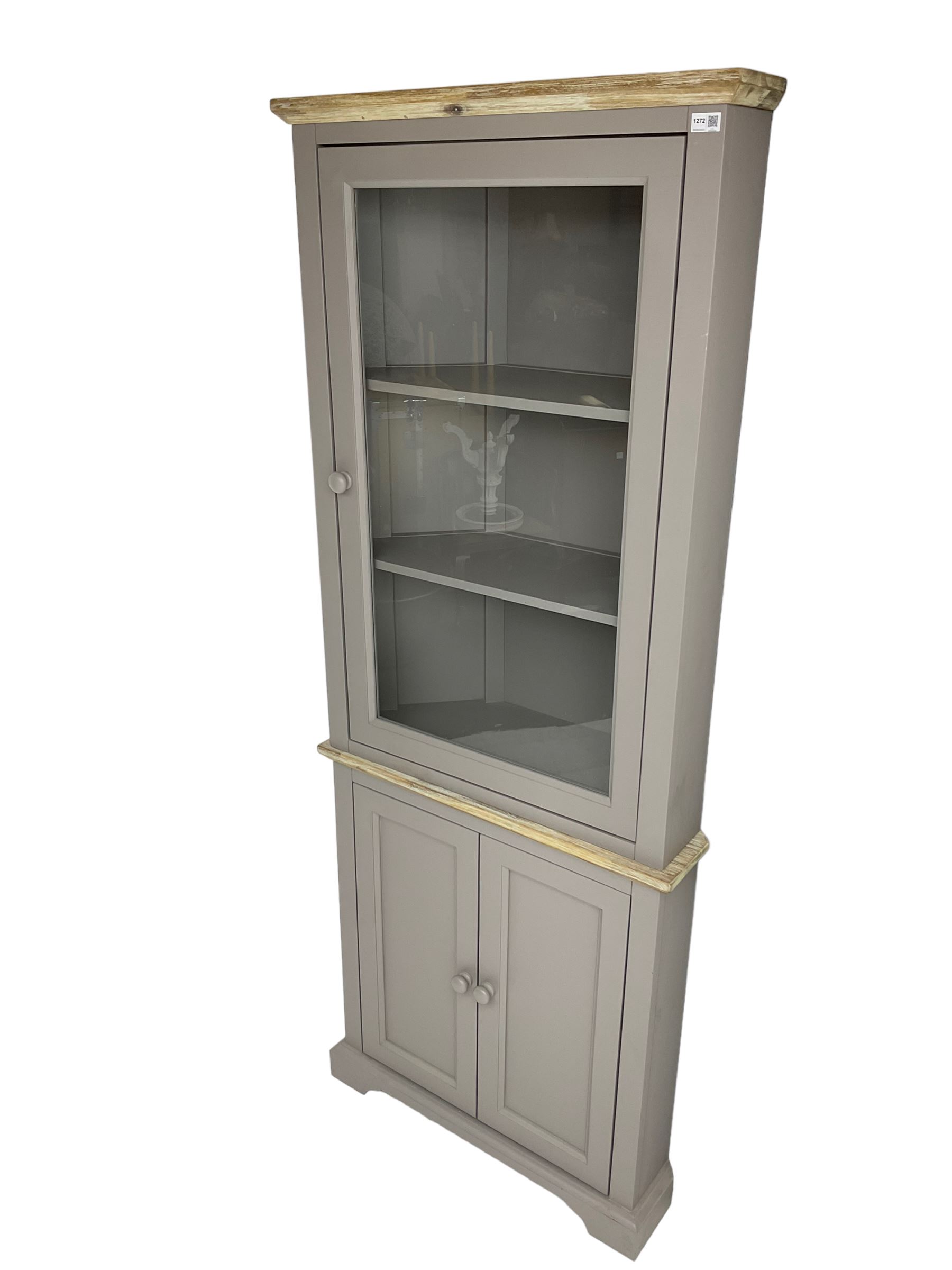 Contemporary teal and oak finish corner cabinet, single glazed door enclosing two shelves, over two panelled cupboard doors