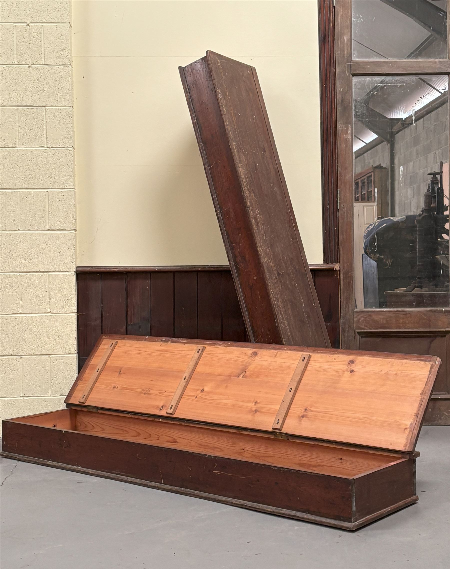 Pair of stained pine long boxes, early 20th century, with hinged lids and moulded base, one with wrought iron carry handle to each end. L203cm, D48cm, D20cm.  - COLLECTION BY APPOINTMENT FROM: The White House, Thirsk Road, Easingwold, York, YO61 3NF - CALL 01723 507111 TO ARRANGE