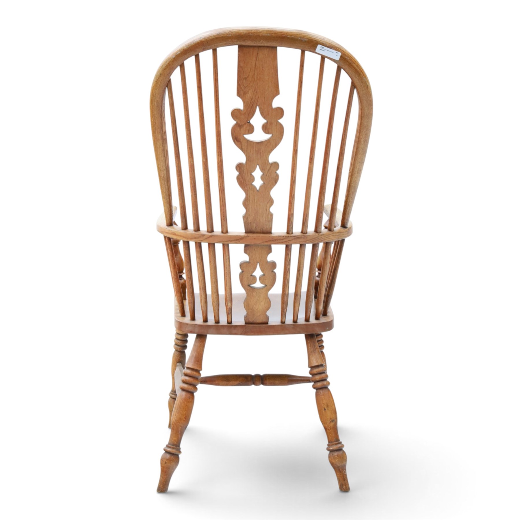 19th century elm Windsor armchair, with central pierced splat, flanked by spindles, dished seat, raised on turned supports united by H-stretcher