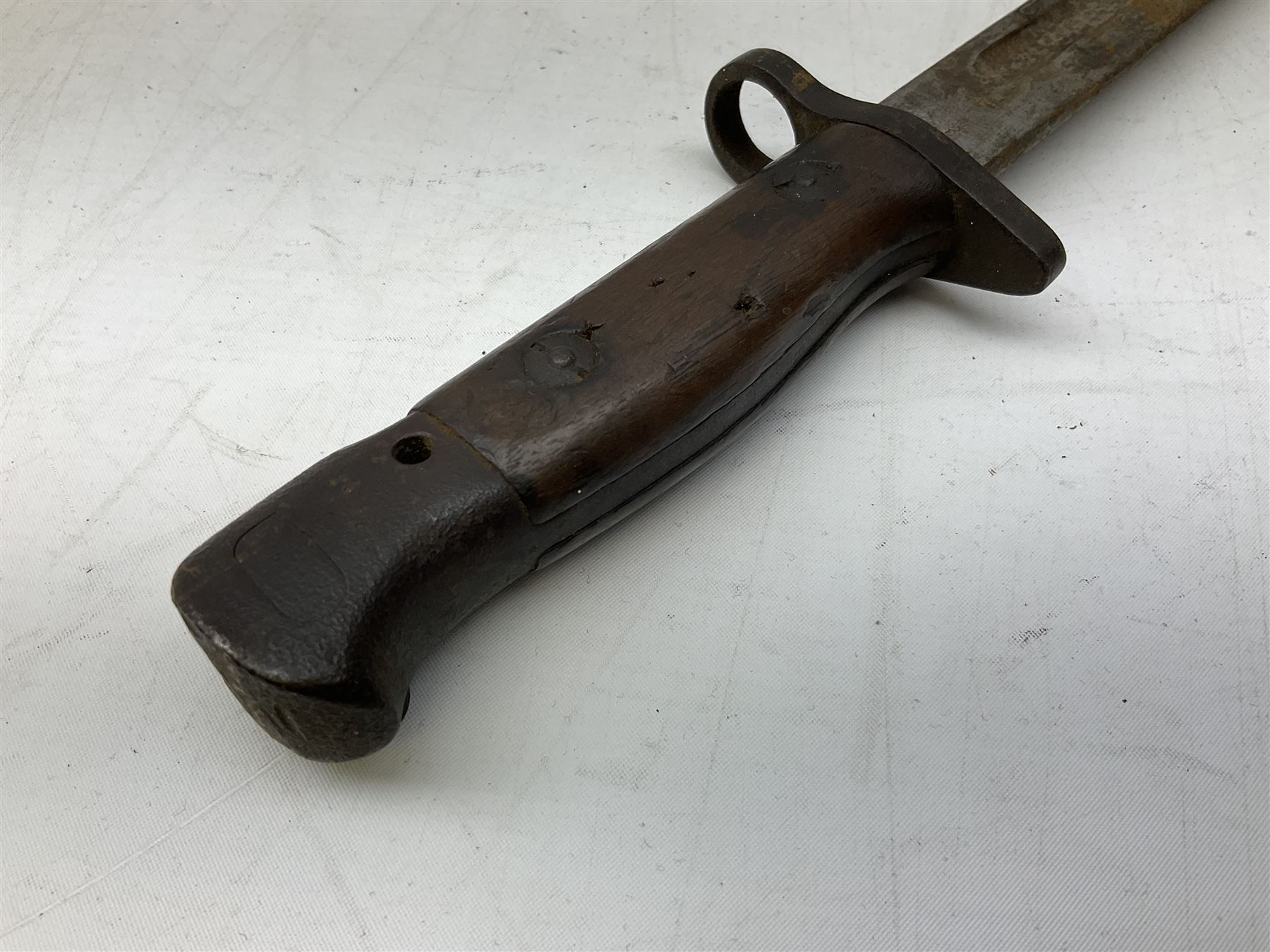 British Pattern 1907 bayonet with 43.5cm fullered steel blade; in leather scabbard with webbing frog L58cm overall; another Pattern 1907 bayonet lacking scabbard; and British Pattern 1888 Mk.I bayonet by Wilkinson London (no scabbard) (3)