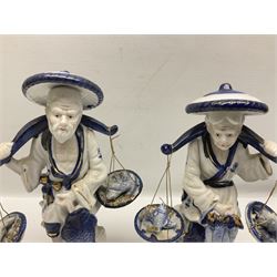 Pair of blue and white fisherman figures, H25cm