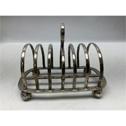 Silver plate seven bar toast rack, of curved form with central ring handle, upon bun feet, H13cm 