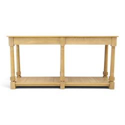 Neptune - 'Edinburgh' limed oak console table, with two
soft close drawers raised on ring-turned column supports,
with a pot shelf raised on square feet