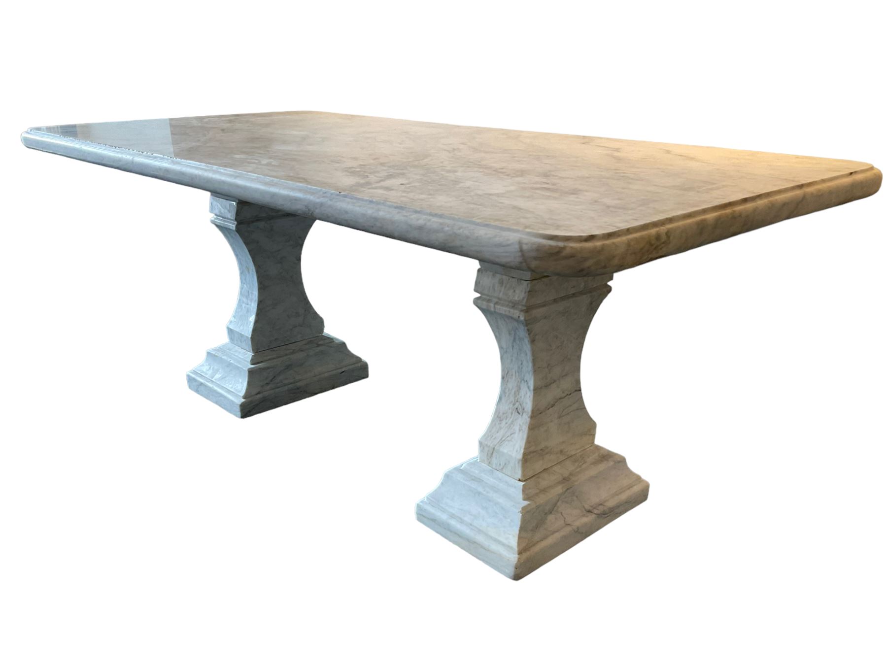 Classical Grecian design Carrera marble centre table, the rectangular single slab top with rounded corners and carved edge, raised on twin pedestals comprised of three pieces with a waisted column on a stepped plinth