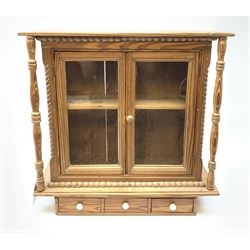Small pine display unit, spindle supports with two glazed doors above three drawers, having ceramic handles,  H51cm, W51cm, D17.5cm