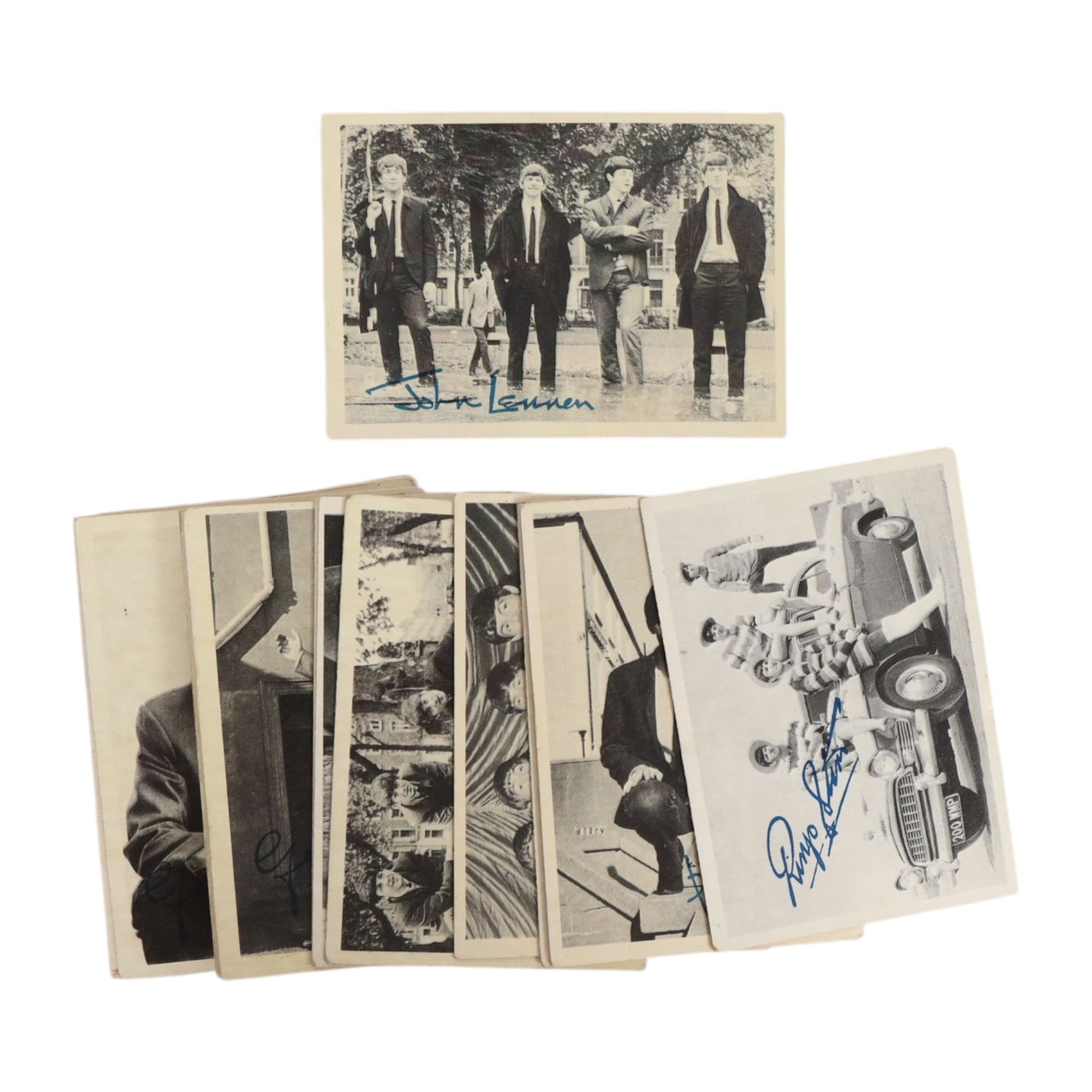 Beatles memorabilia, comprising John Lennon patch, nineteen Beatles chewing gum cards, collection of photographs and postcards including Eskimo Frozen Foods examples, two Beatles City carrier bags and Yellow Submarine cardboard cut-outs