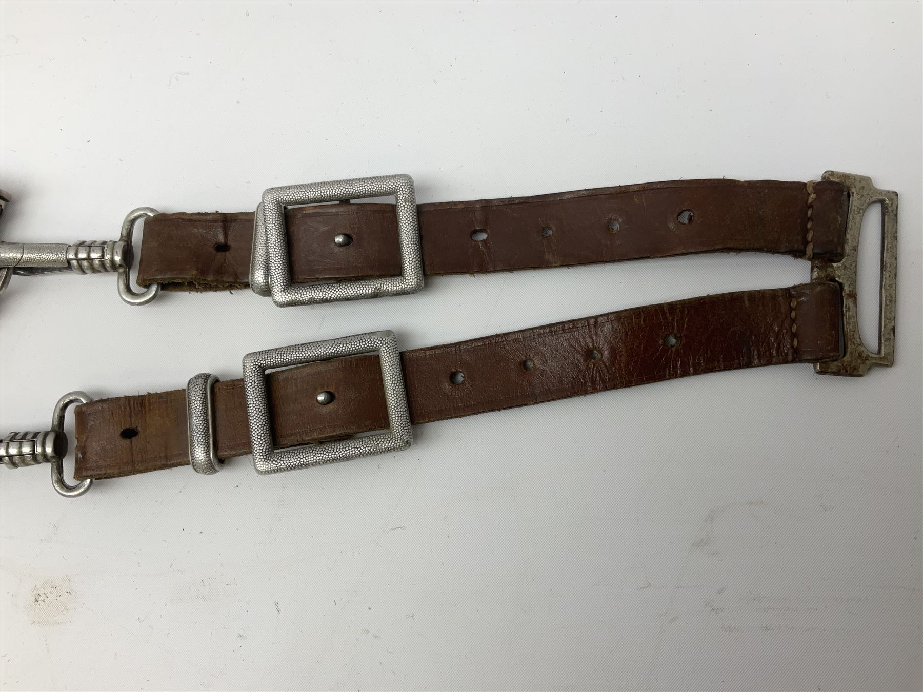 German Reichsarbeitdienst RAD Leader's Hewer dagger, the 26cm single edged scimitar shaped blade with narrow fuller, etched Arbeit adelt; by E.D. Wusthof, Solingen; the aluminium hilt with spade and wheat ear langet; two piece white plastic grip and eagle head pommel; pebbled steel scabbard engraved with ears of wheat and strapwork with double leather hangers L40cm overall