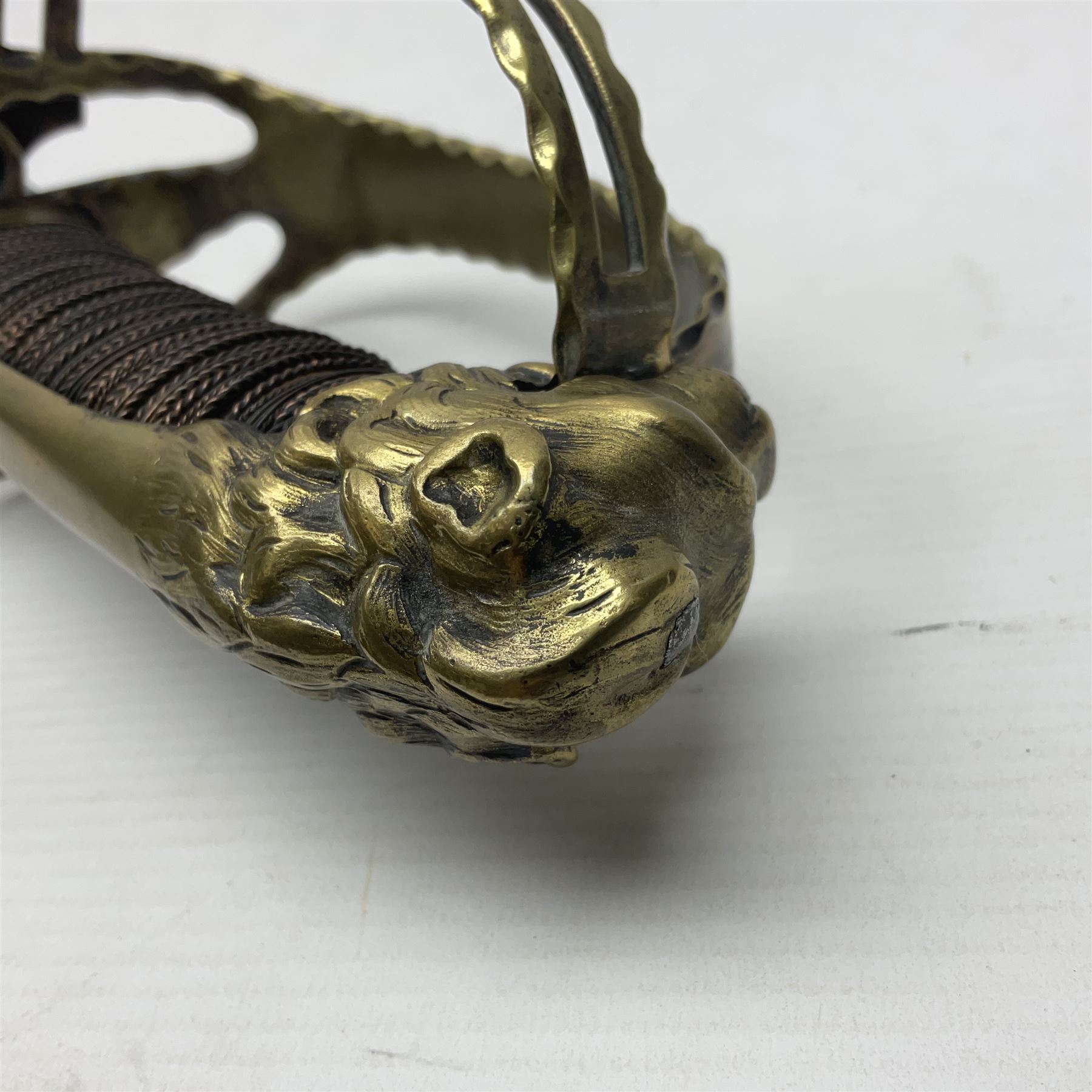 Late 18th century French 1st Empire Troupe a Pied Petit Montmorency Branch Tournante officer's sword, with 72.5cm slightly curving fullered blade, pierced brass hilt with lockable swivelling bar, fully wire-bound grip with lion head pommel, L88cm overall (no scabbard)