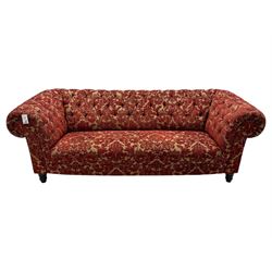 Late 20th century upholstered Chesterfield sofa, in red damask floral fabric, with deep buttoned back and arms, scrolled arms at equal height to back, on turned front supports