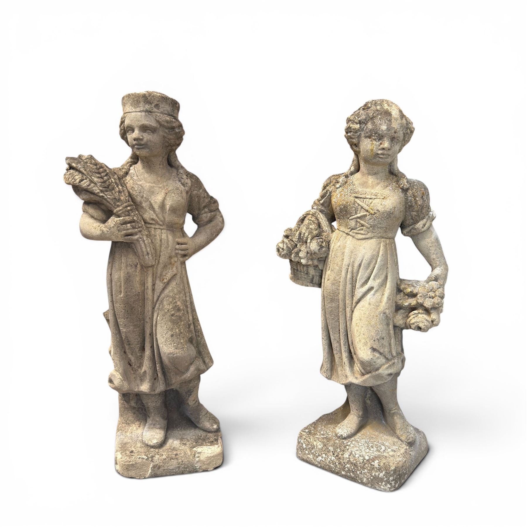 Lucas Stone - pair of cast stone garden figures, modelled as young female figures holding wheat sheafs and baskets of flowers, each on square bases, weathered finish, makers mark stamped to base