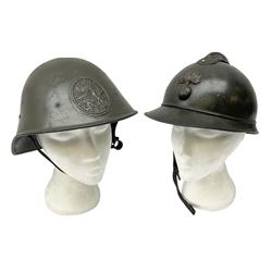 WW2 French M-26 Adrian Pattern Steel Helmet, original olive drab paint finish; flaming grenade badge to the front signifying issue to an Infantry regiment; original leather liner and leather chinstrap; and WW2 Dutch steel helmet with liner and chin strap (2)