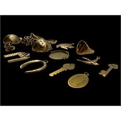 9ct gold charms, including crossed swords, signet ring, horseshoe and leaf, and a 14ct gold fireplace charm