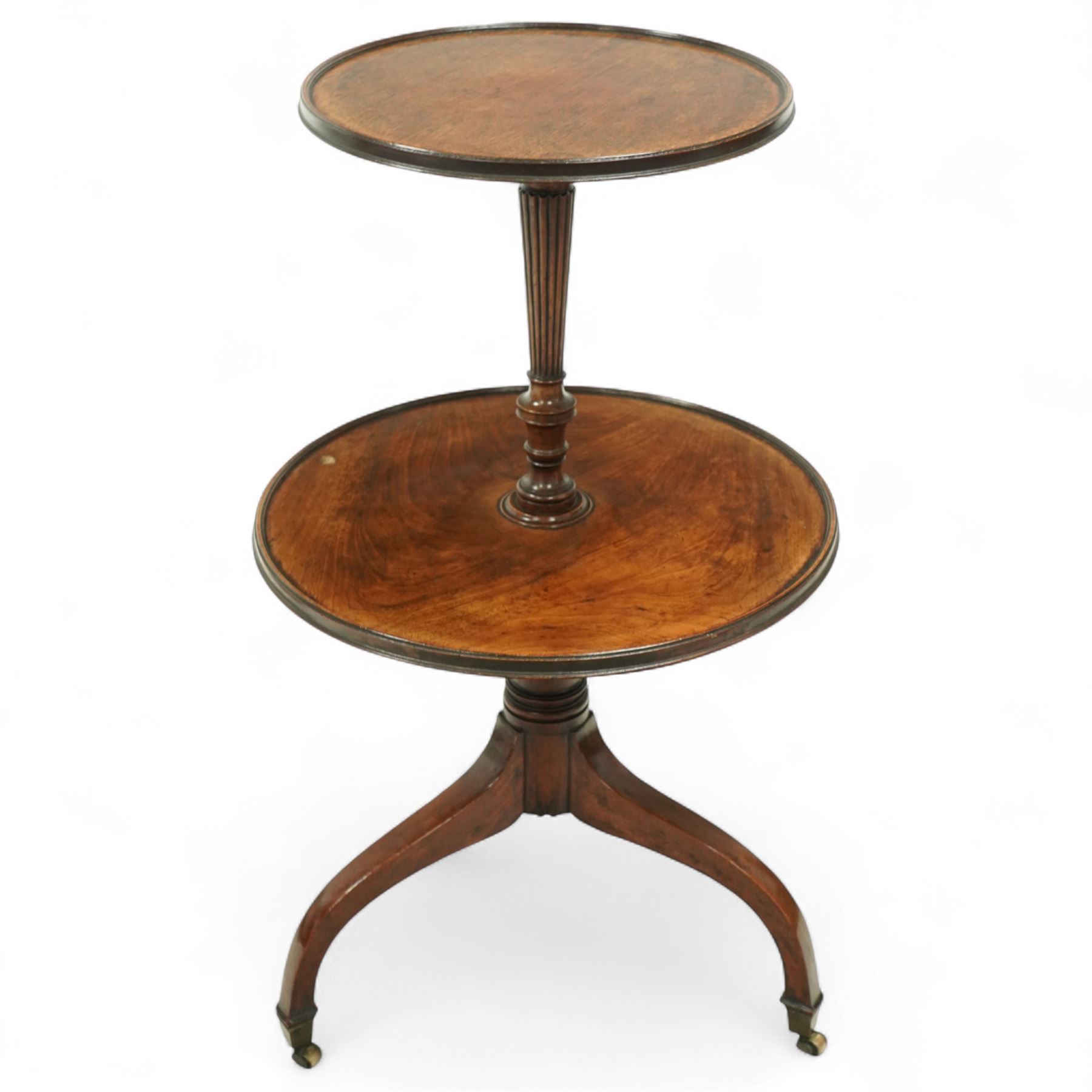Regency mahogany dumb waiter, with two graduated circular tiers raised on a turned column and tripod base terminating in brass castors, circa 1820