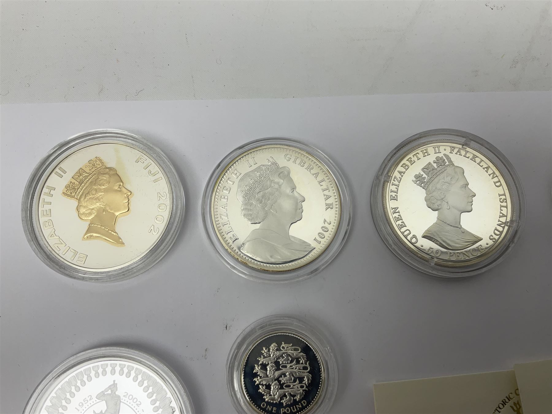 Thirteen silver coins, including Queen Elizabeth II Solomon Islands 2002 sterling silver five dollars, Alderney 2002 sterling silver five pounds, Fiji 2002 sterling silver ten dollars, United Kingdom 2003 one ounce fine silver Britannia, 2003 'Give Women The Vote' fifty pence etc, all with some form of certificate