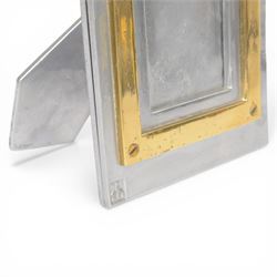 David Marshall photo frame, of cast aluminium mounted with a smaller brass frame, the maker's mark impressed to the lower left hand corner, H23cm