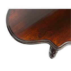 19th century Irish rosewood centre table, the shaped and moulded top over shaped apron carved with scrolled foliage, on serpentine supports carved with bell flowers, the supports united by anthemion carved finial and s-scroll x-framed stretchers