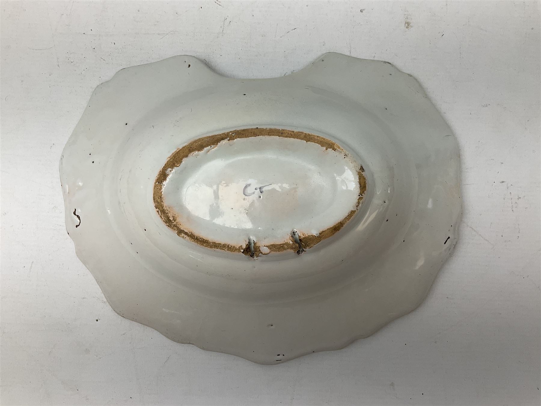 19th century French faience barber's blood-letting bowl, with painted floral decoration in polychrome upon plain ground, with painted initials CT mark beneath, L31cm