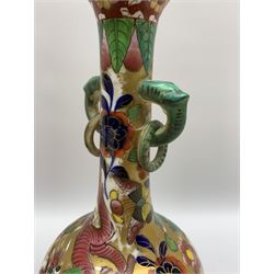 Pair of early 19th century Miles Mason vases, the baluster bodies with tall slender necks supporting twin stylised trunk handles with rings, decorated with Chinese dragons, butterflies, and blossoming flowers against a gilt ground, with spurious Chinese marks beneath in iron red, H27.5cm