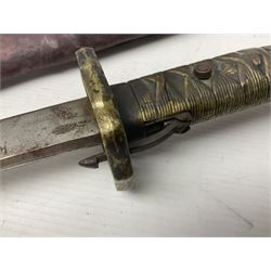 Copy of a WWII Japanese NCO sword, the 65cm slightly curving blade stamped with pseudo Japanese characters and cast brass simulated cord bound grip; in officer's leather bound field scabbard L97cm overall