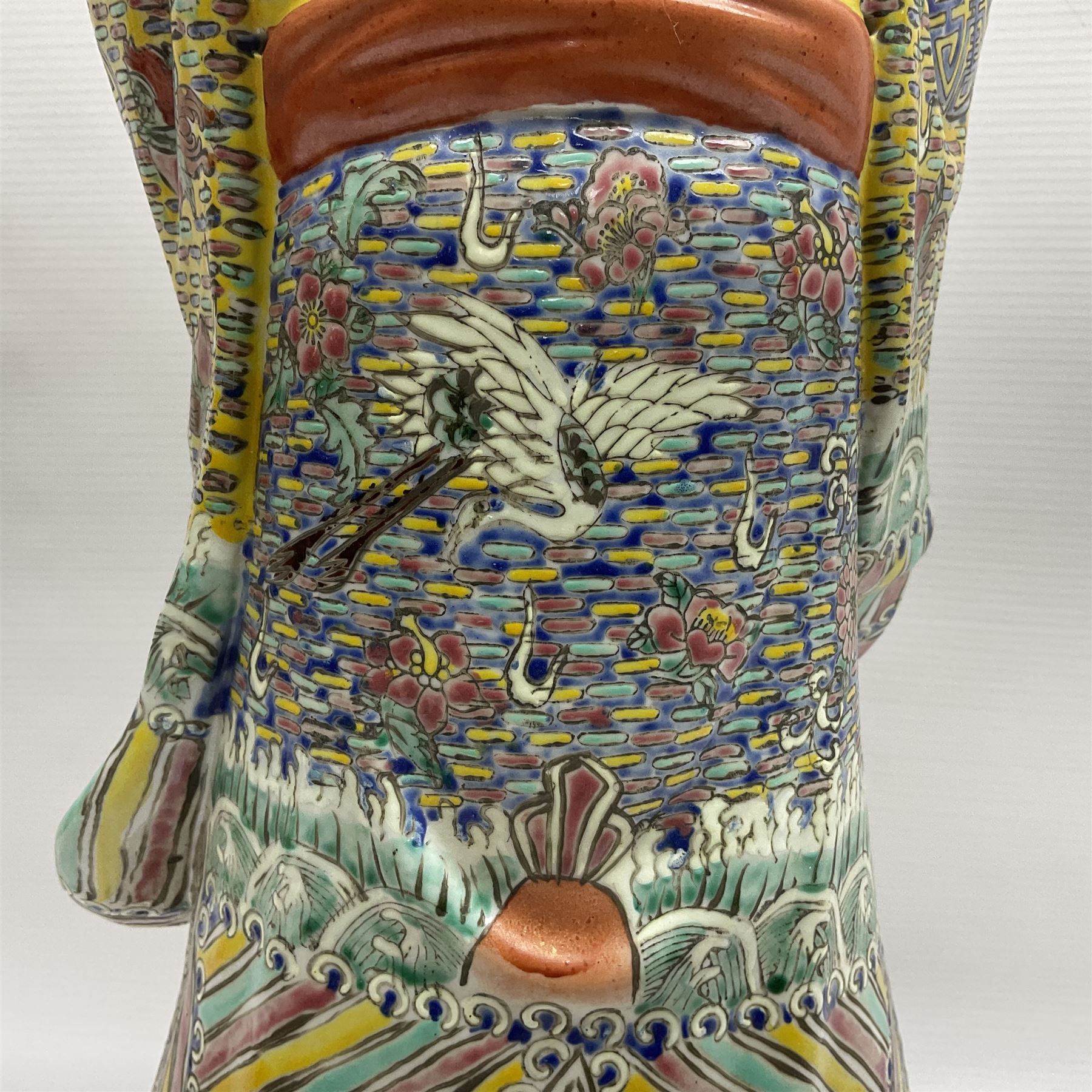 Chinese Republic Period porcelain figure, modelled as Shoulao, wearing elaborately enamelled robes decorated with peaches and flower heads, with impressed mark beneath, H55cm
