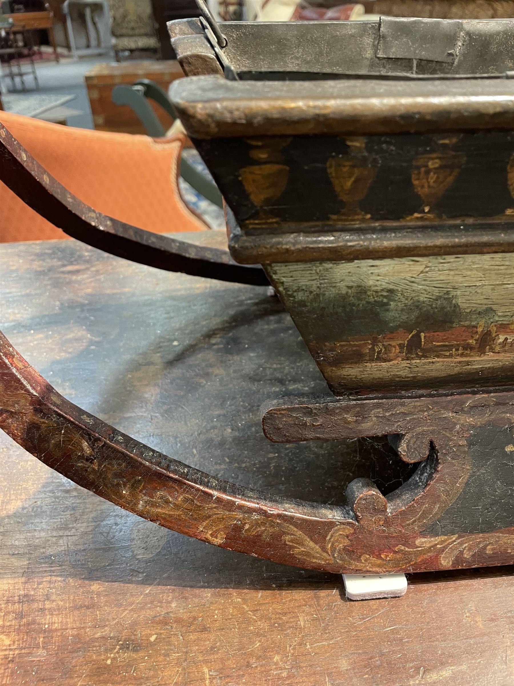 Unusual 18th century small Northern European wooden sled, with curved scroll back, the sides painted with coastal shipping scenes, the interior with removable zinc liner, upon curved irons painted with flower heads, H36cm W56cm D29cm