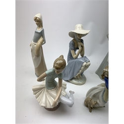  A group of Spanish figurines, to include examples bv Lladro and Nao.  