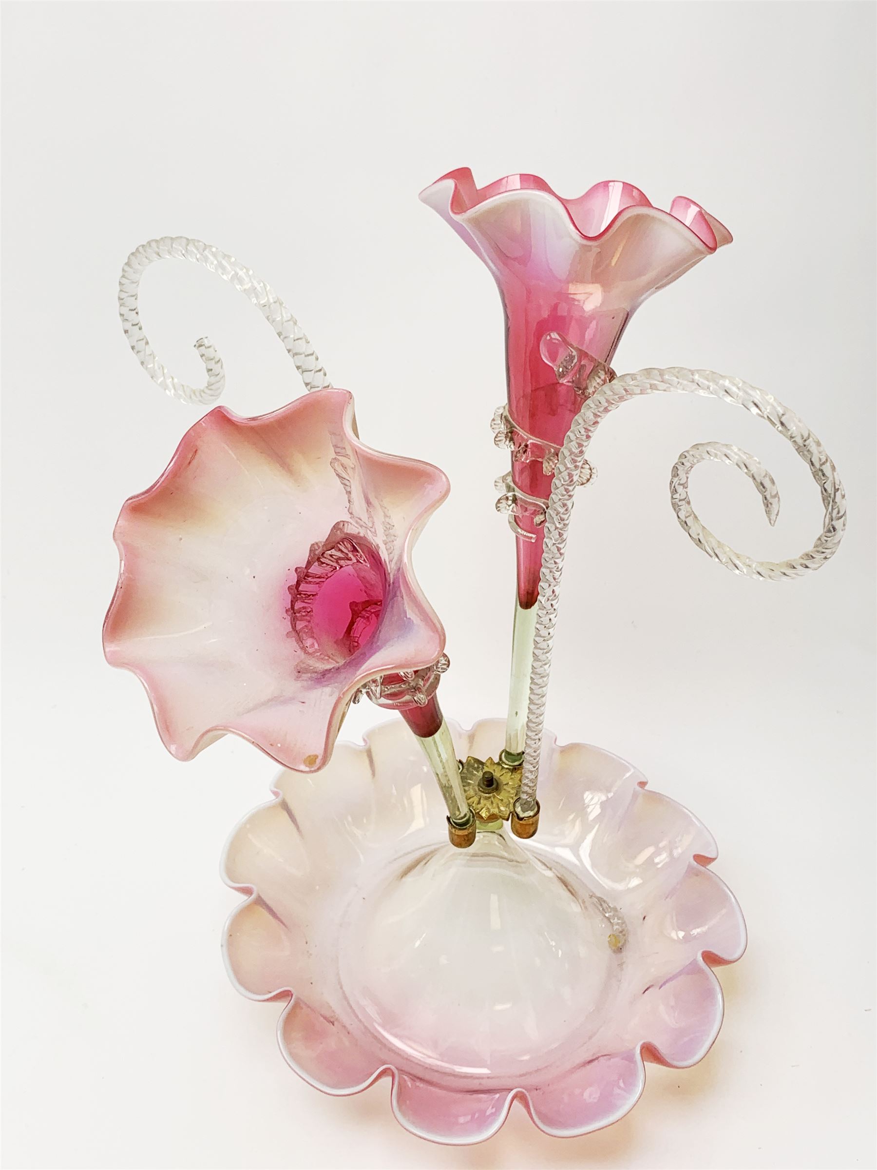A Victorian cranberry and Vaseline glass epergne, the frilled bowl supporting two frilled trumpets and two canes, H41cm. 