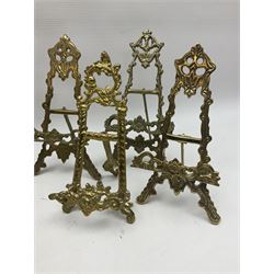 Nine ornate cast brass easel stands of various sizes, H24cm