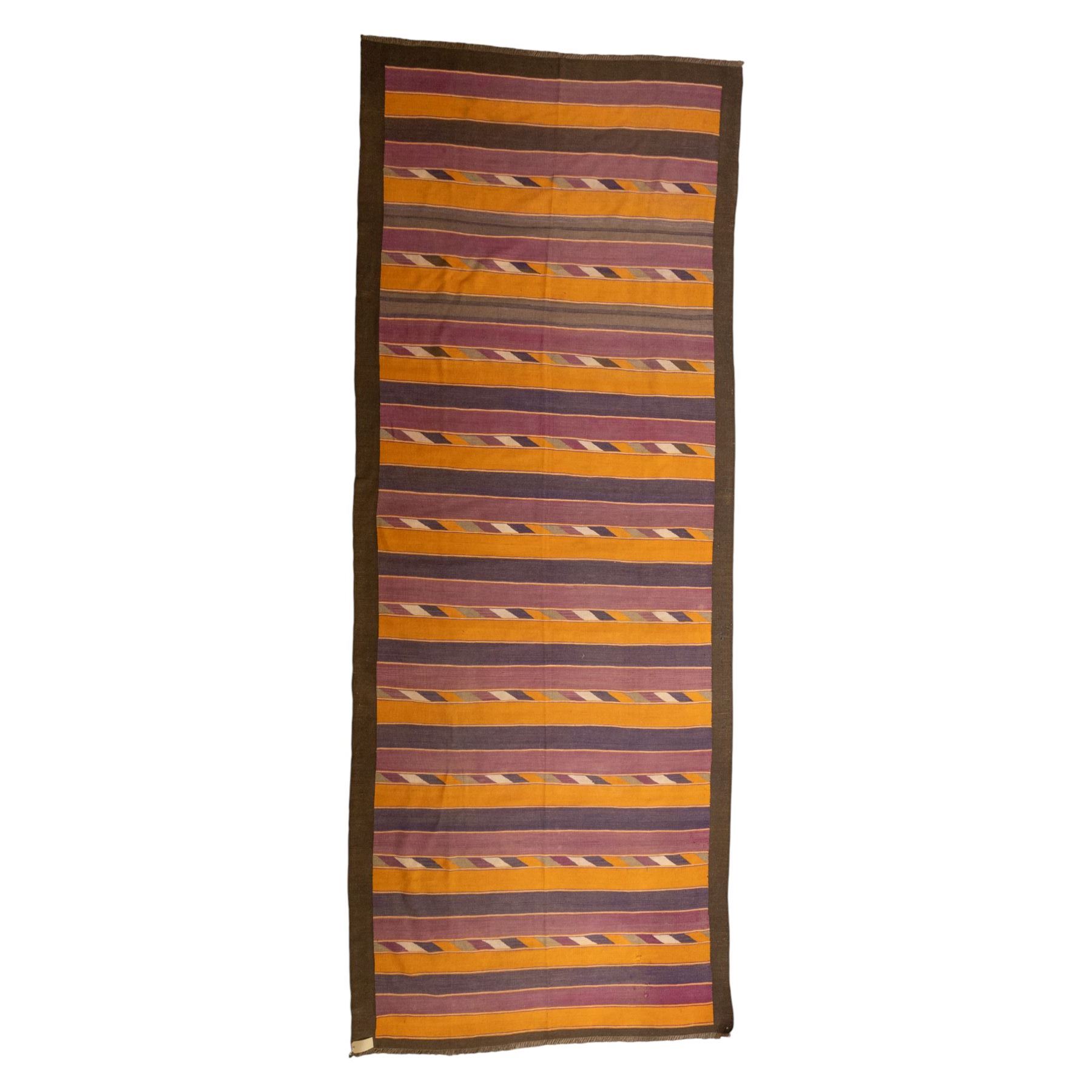 South West Persian Qashqai flatweave kilim, field decorated with bold horizontal bands in shades of aubergine, plum and orange, ochre, olive and lilac, interspersed with narrow registers of diagonal chevron motifs in cream and dark brown, framed by brown end panels, with fringe ends 