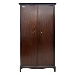 Stag Minstrel - pair of mahogany double wardrobes, comprising a larger wardrobe with a shelf and hanging rail behind two panelled doors (W127cm, D59cm, H177cm); and a smaller wardrobe enclosing a single hanging rail (W96cm, D59cm, H177cm), both finished with projecting cornices and raised on bracket feet



