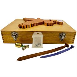 Falconry equipment, including two eyelet tools, various swivels, jessies, bells etc, within a wooden box  