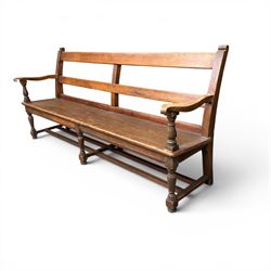 Early 20th century pine and oak bench seat, stained pine rail back frame with shaped oak arms
