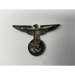 Three WW2 German visor cap badges comprising Police eagle, Political leaders eagle and Norwegian Quisling Party; all with fixings; and WW2 Polish visor cap badge (4)