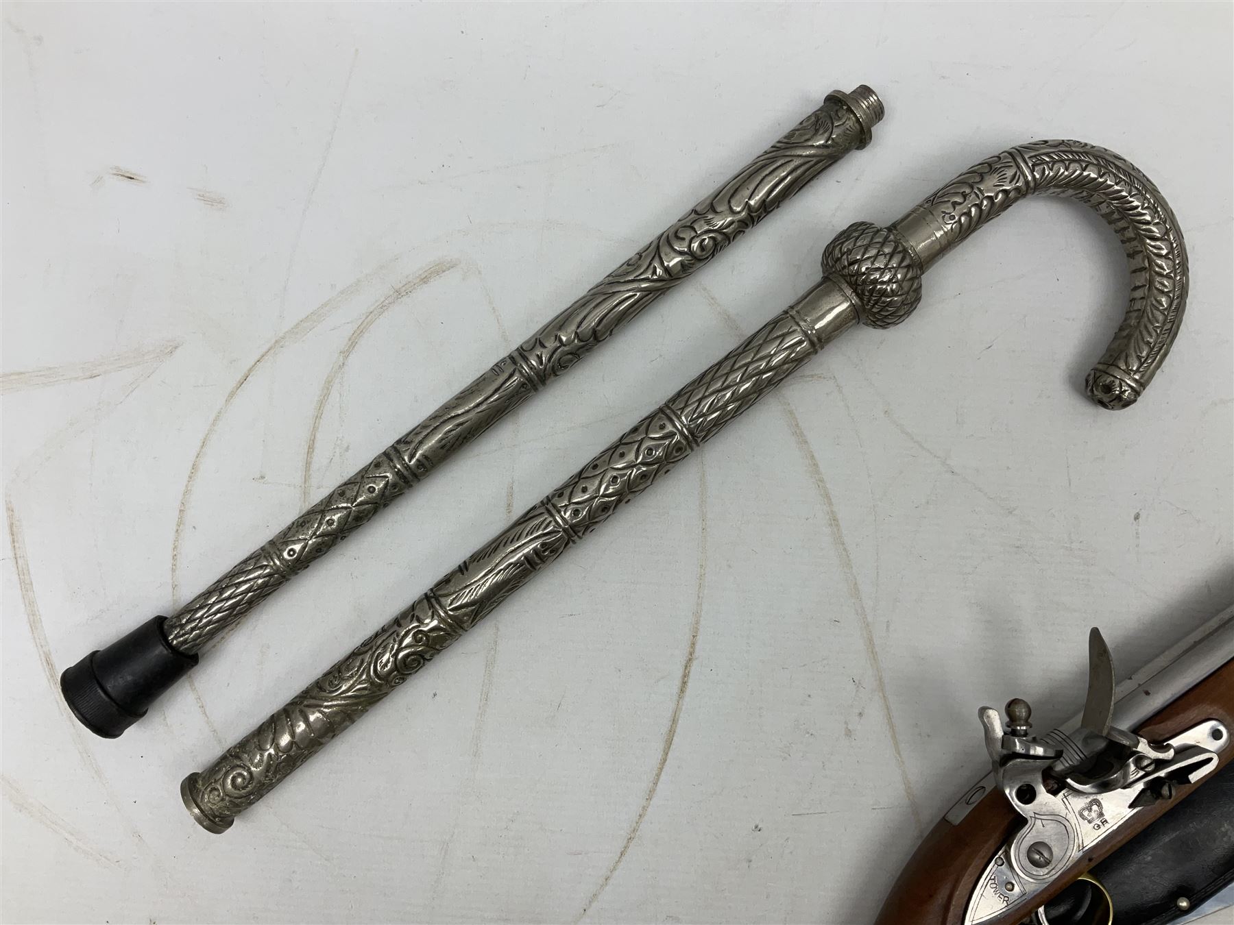 Reproduction non-firing flintlock pistol with brass skull crusher butt, the lock-plate inscribed 'Tower' and 'GR' L40cm; Sabre Japan Original Bowie Knife in sheath; and Indian embossed nickel two-piece walking cane (3)