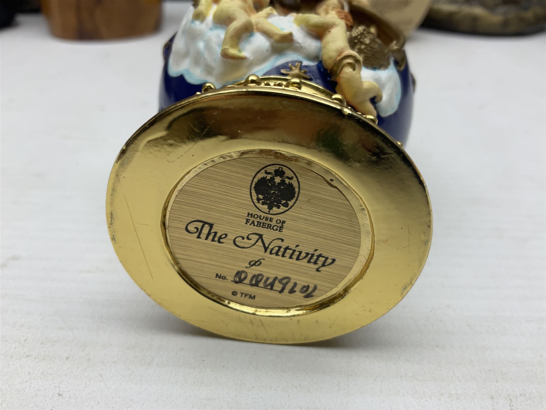 Franklin Mint House of Faberge 'The Nativity' ceramic egg, together with a Russian doll decorated with nativity scenes, Cinque Ports Pottery monk salt and pepper shaker and other monk figures, etc