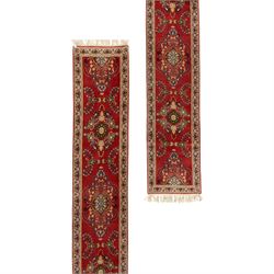 Kashan design wool runner, red field decorated with repeating floral medallions, palmettes...
