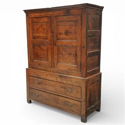 Georgian rustic oak housekeeper’s cupboard, moulded cornice above a pair of fielded panel cupboard doors enclosing a boarded interior with central divider and hanging hooks, the base fitted with two long drawers with brass swan neck handles, raised on stile supports