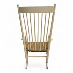 Mid-20th-century Scandinavian painted high-back rocking chair, curved top rail above slender spindle back, shaped arms with rounded ends above hand-woven rush seat, tapered rockers reinforced by turned stretchers 